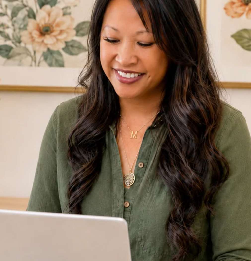 meisie beauvais in front of her laptop typing content for her about us page